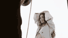 a woman in a trench coat is posing for a picture