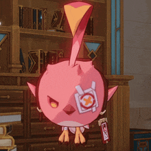 a pink bird with a sticker on its eye that says " x "