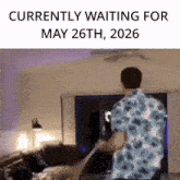 a man in a floral shirt is standing in a living room .