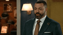 a man in a suit and tie with a pin that says ' u.s. army '