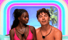 a man and a woman are standing next to each other with a rainbow in the background