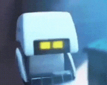 a close up of a white robot with two yellow lights on its face .
