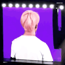 a person 's back is shown in front of a purple background with midnight blue written on it
