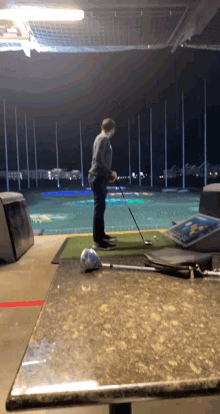 a man is swinging a golf club on a green