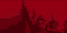 a woman in a black bra is dancing in a red room with other women .