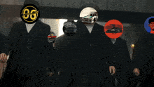 a group of men wearing suits and hats with one man wearing an og logo on his head