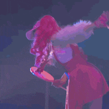 a woman in a red dress is holding a bat in her hand