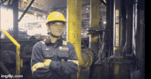 a man wearing a hard hat and overalls stands in front of a pipe that says ingflip.com on the bottom