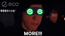 a man wearing a mask with smiley faces on his eyes and the words more written below him