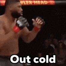 a man in a boxing ring with the words out cold on the bottom