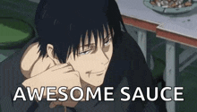 a man in a black shirt is sitting at a table with a plate of food in the background and says `` awesome sauce '' .