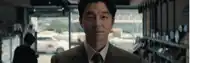 a man in a suit and tie is standing in front of a store window