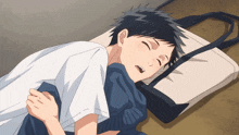 a boy laying on the floor with his eyes closed and a bag behind him