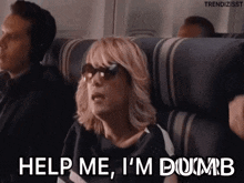 a woman wearing sunglasses is sitting on an airplane and asking for help .