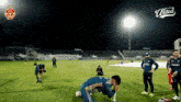 a group of soccer players are on a field with a united logo in the corner