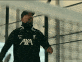 a man wearing a black shirt that says ' jk ' on it