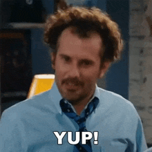 a man with a mustache is wearing a blue shirt and tie and saying yup .
