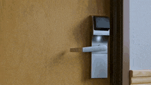 a wooden door with a stainless steel door handle and a digital door lock