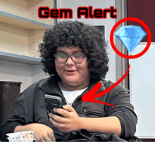 a man with curly hair and glasses is looking at his phone with a diamond in the background that says " gem alert "