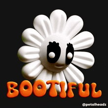 a white flower with black eyes and the word bootiful in orange