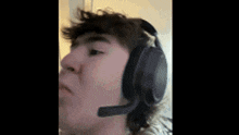 a close up of a person wearing headphones with a microphone on their head .