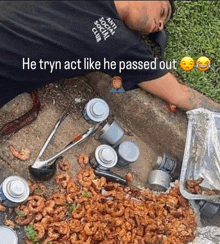 a man wearing an anti social social club shirt is laying on the ground next to a pile of food