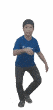 a boy wearing a blue shirt and black pants is dancing