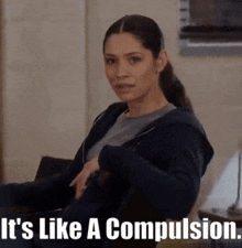 a woman is sitting in a chair with the words " it 's like a compulsion " behind her