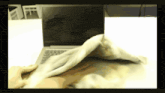a laptop is being wiped with a cloth on a table