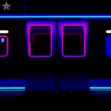 a man is dancing in a dark room with neon lights