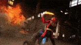 a man in a red and gold superhero costume is fighting another man