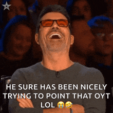 a man wearing sunglasses is laughing with a caption that says he sure has been nicely trying to point that oyt lol