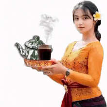 a woman is holding a tray with a teapot and a cup of tea .