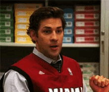 a man wearing a red vest with miami written on it
