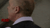 a close up of a man 's face with the words ' lease underst ' in red