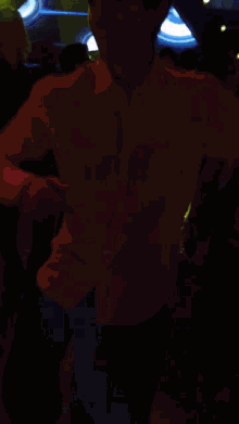 a man in a white shirt is dancing in a club