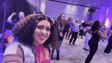 a woman taking a selfie with a lanyard around her neck that says ' amanda ' on it