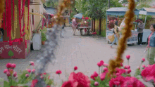 a woman walking down a street in front of a store that says ' ice cream '