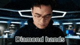a man wearing glasses and a black hoodie with the words diamond hands above him .