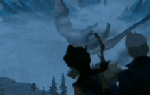 a silhouette of a person standing in front of a giant dragon