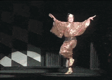 a man in a kimono is dancing with another man in a green kimono