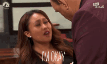 a woman says i 'm okay while a man looks on
