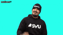a man wearing a beanie and a sweatshirt that says svu on it
