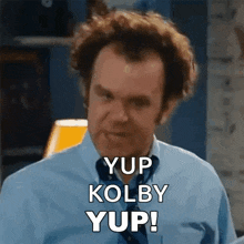 a man in a blue shirt and tie says yup kolby yup .