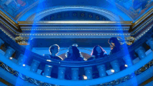 a group of people standing on a balcony with whooo written in yellow