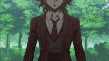 a man in a suit and tie is standing in front of trees