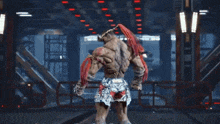 a very muscular man with red hair and a tattoo on his back