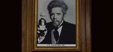 a framed portrait of j.b. guggins , sr. holding a puppet