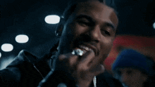 a man with a ring on his finger is eating a piece of food
