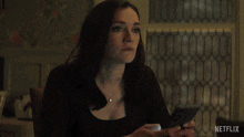 a woman says " you shouldn 't have netflix " in front of a window